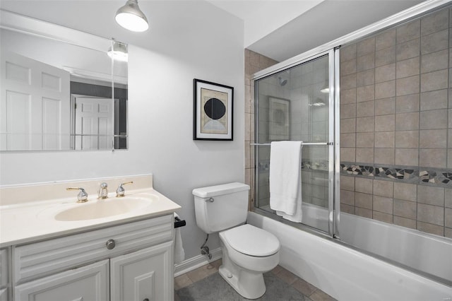 full bathroom featuring enclosed tub / shower combo, vanity, tile patterned floors, and toilet