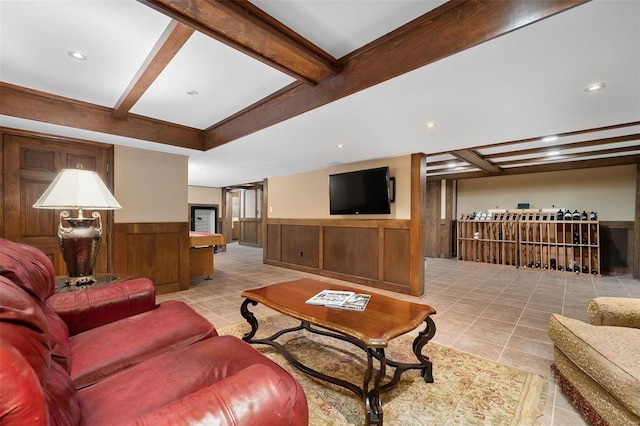 tiled living room featuring beamed ceiling