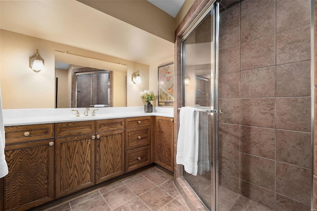 bathroom with vanity, a shower with shower door, and tile patterned flooring