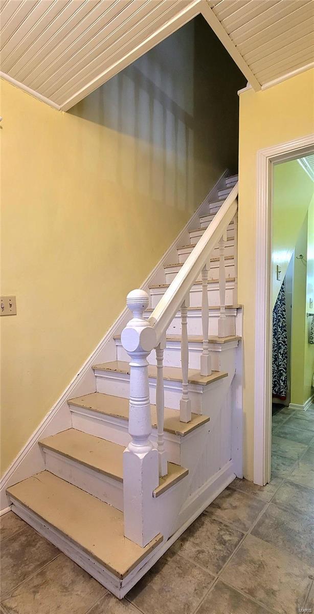 stairs featuring wooden ceiling