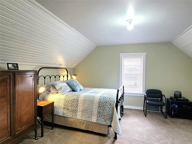 carpeted bedroom featuring lofted ceiling