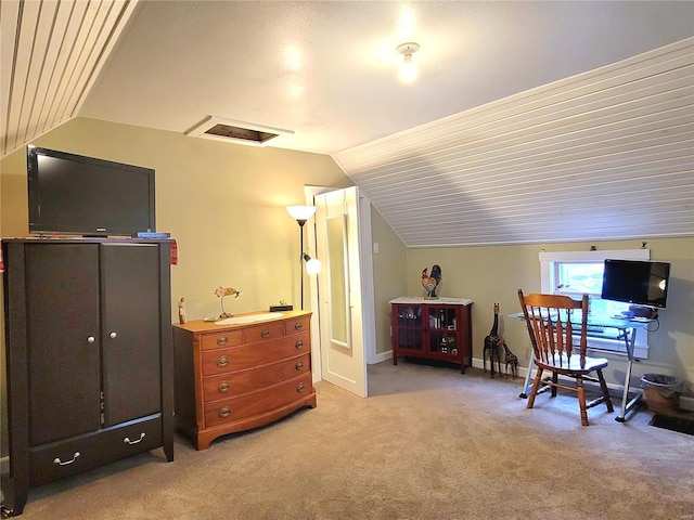 carpeted office space with vaulted ceiling