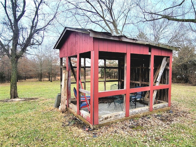 view of outbuilding with a lawn