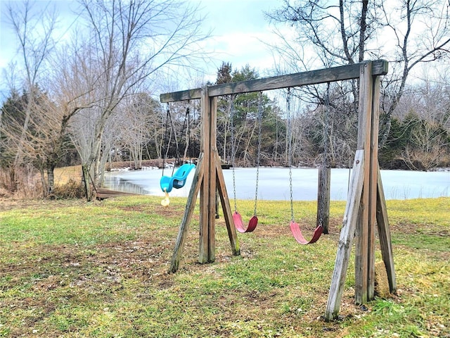 view of playground featuring a water view and a lawn