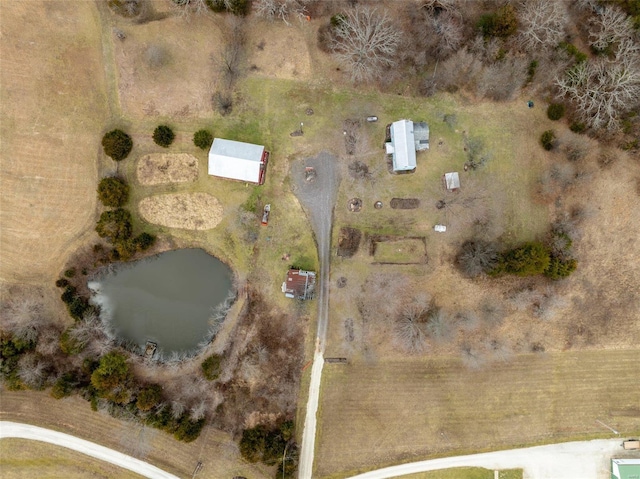 birds eye view of property with a water view and a rural view