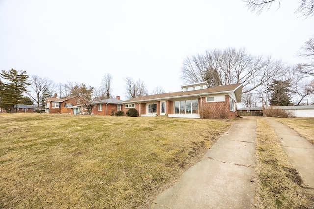 ranch-style home with a front lawn