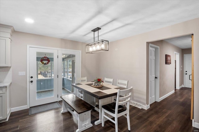 dining space with dark hardwood / wood-style flooring