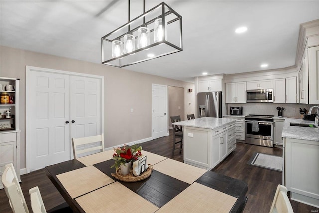 dining space featuring sink and dark hardwood / wood-style floors