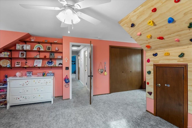 bedroom featuring light carpet, rustic walls, a closet, and ceiling fan