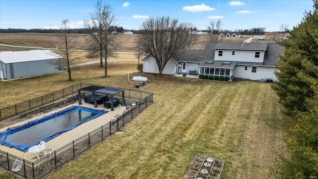 exterior space with a shed, a yard, a sunroom, and a covered pool