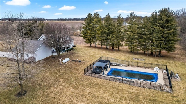 view of pool with a rural view and a yard