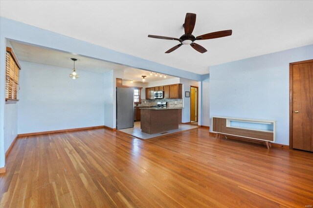 unfurnished living room with light hardwood / wood-style floors and ceiling fan