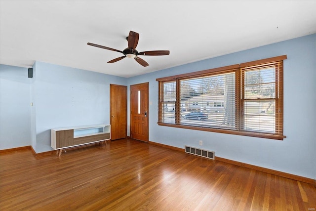 spare room with wood-type flooring and ceiling fan