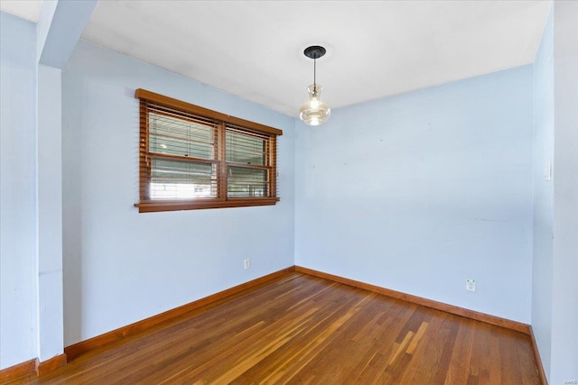 spare room featuring dark wood-type flooring