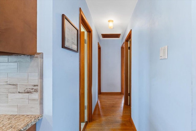 corridor with wood-type flooring