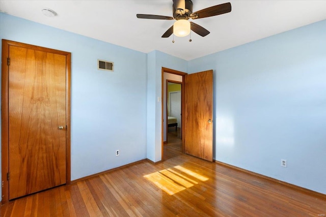 unfurnished bedroom with wood-type flooring and ceiling fan