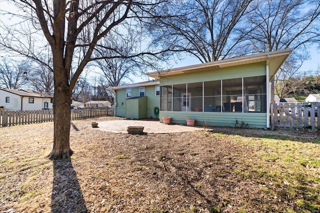 rear view of house with a sunroom and a patio area