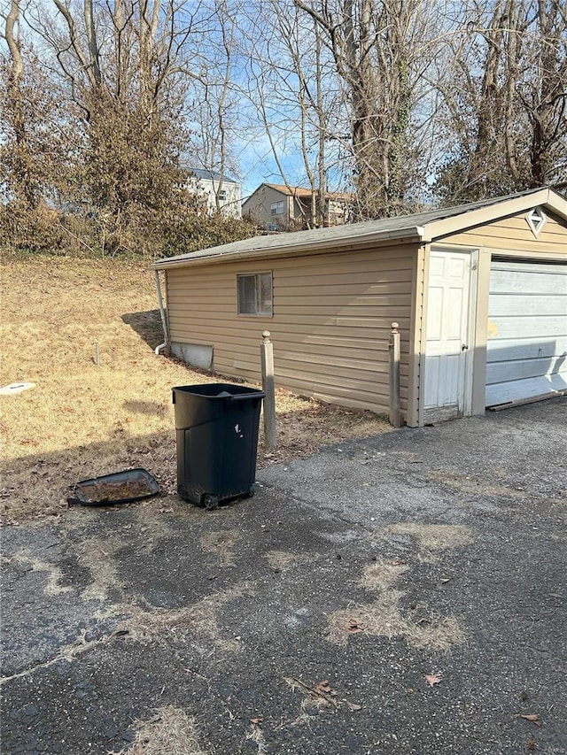 view of side of property featuring a garage and an outbuilding