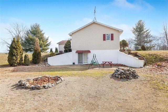 view of side of property featuring a fire pit