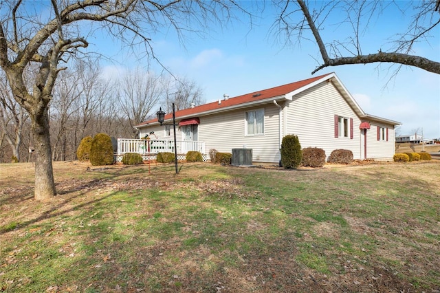 view of side of property with a yard and cooling unit