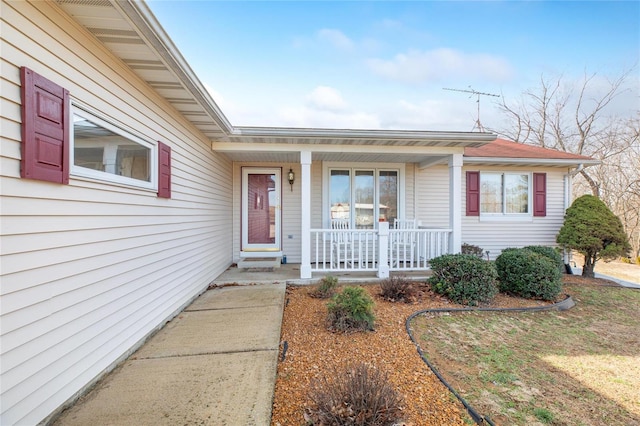 view of exterior entry with covered porch