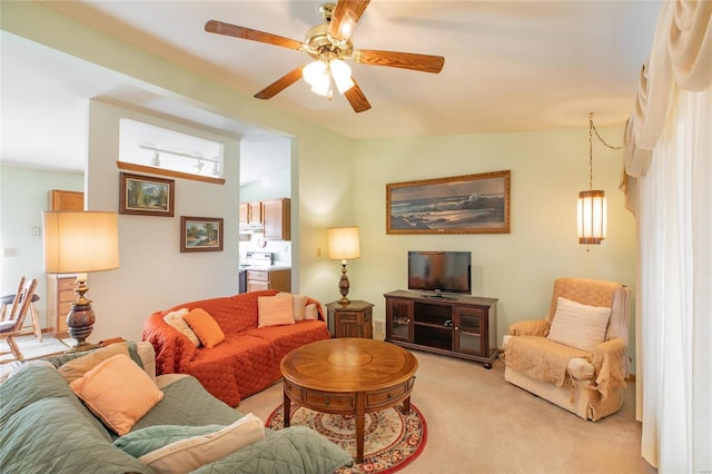 living room featuring rail lighting, light carpet, and ceiling fan