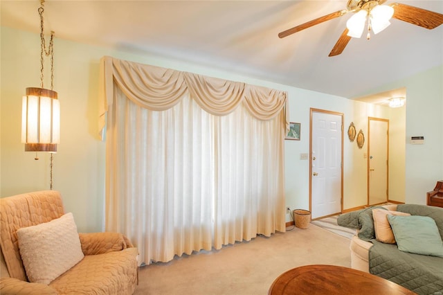 carpeted living room featuring ceiling fan