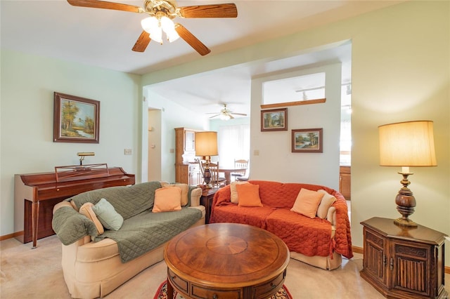 living room featuring ceiling fan and light carpet