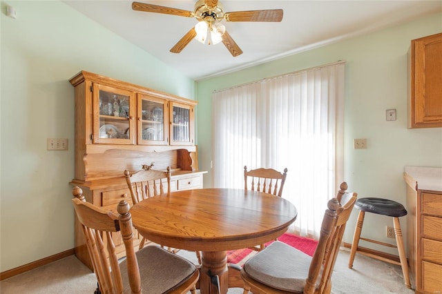 dining area with light carpet and ceiling fan