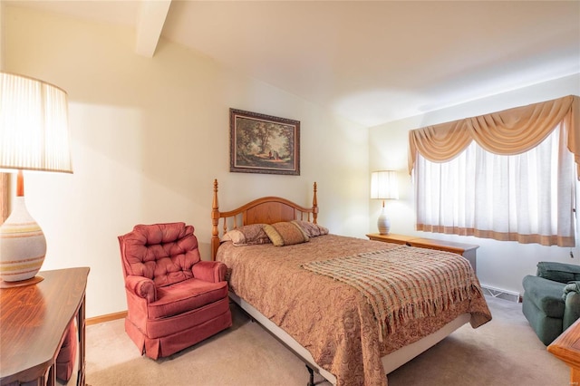 bedroom featuring vaulted ceiling with beams and light colored carpet