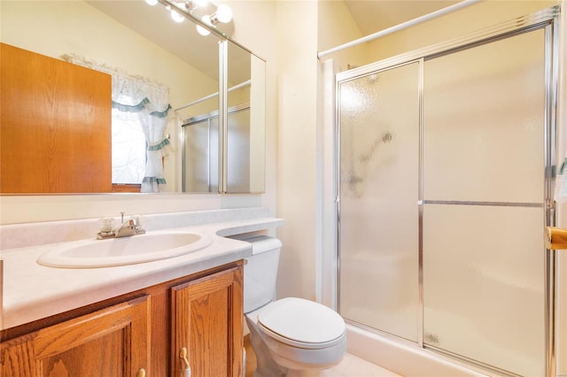 bathroom with an enclosed shower, vanity, and toilet