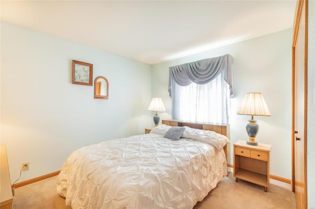 bedroom featuring light carpet