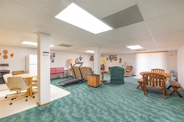 interior space featuring a paneled ceiling and carpet flooring