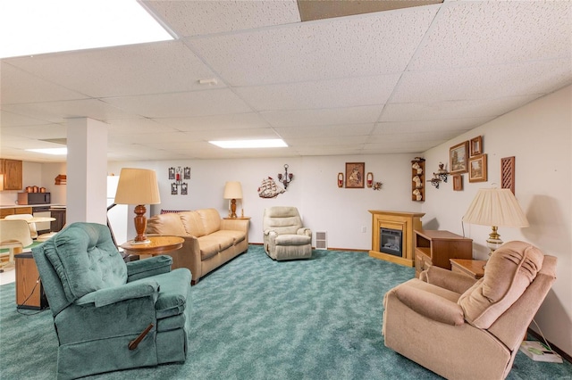 living room with carpet flooring and a drop ceiling