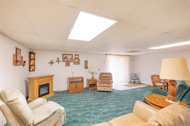 carpeted living room with a drop ceiling