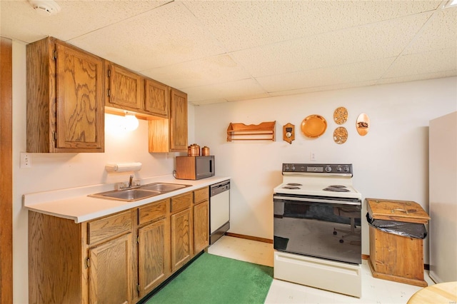 kitchen featuring stainless steel dishwasher, sink, and white range with electric stovetop