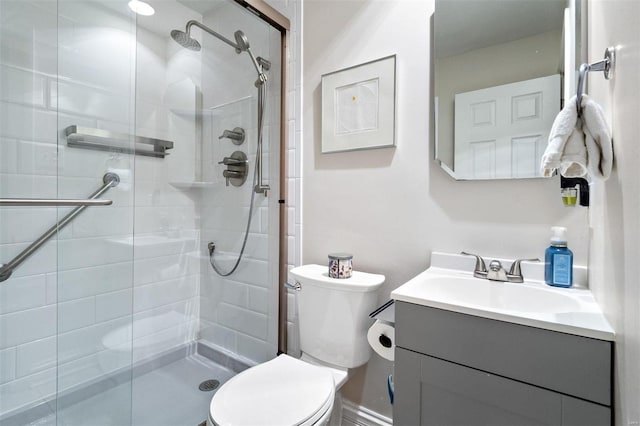 bathroom with vanity, an enclosed shower, and toilet