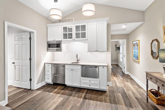 kitchen with stainless steel appliances, hanging light fixtures, sink, and white cabinets