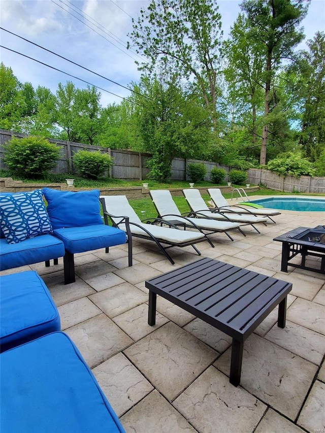 view of patio / terrace with an outdoor living space and a fenced in pool