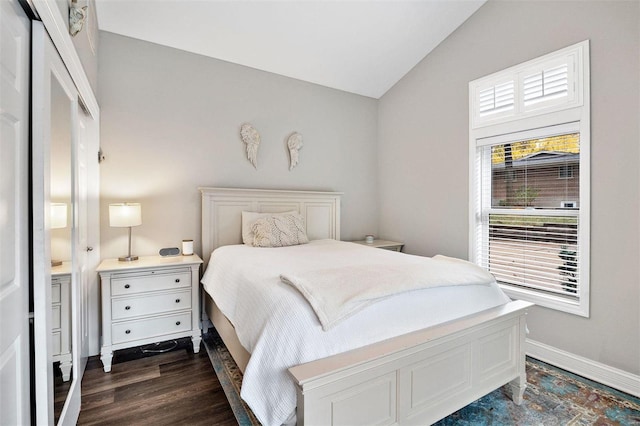 bedroom with dark wood-type flooring and vaulted ceiling