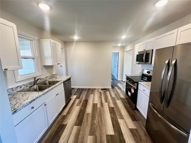 kitchen with white cabinetry, sink, dark hardwood / wood-style floors, and appliances with stainless steel finishes