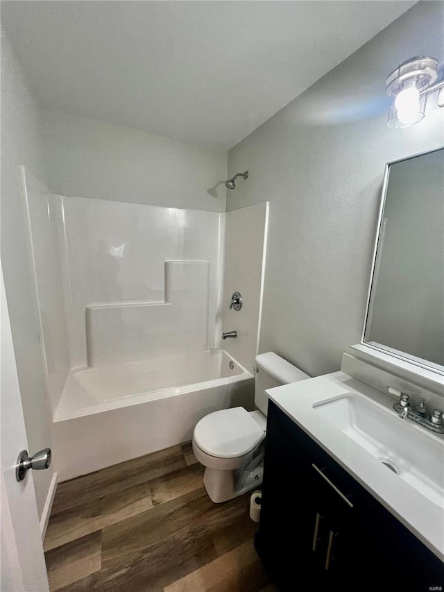 full bathroom with shower / bathtub combination, wood-type flooring, toilet, and vanity