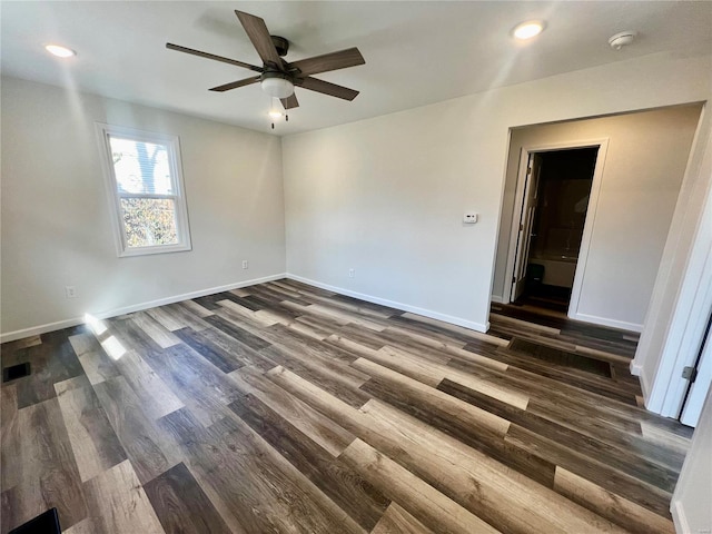 empty room featuring dark hardwood / wood-style floors and ceiling fan