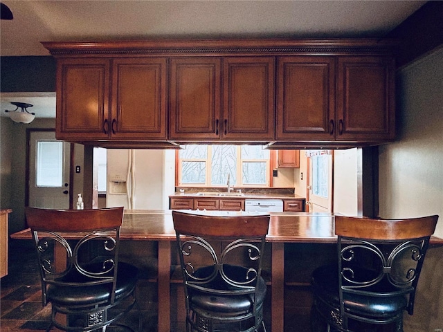 kitchen with white refrigerator with ice dispenser and sink