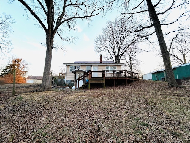 rear view of property featuring a wooden deck