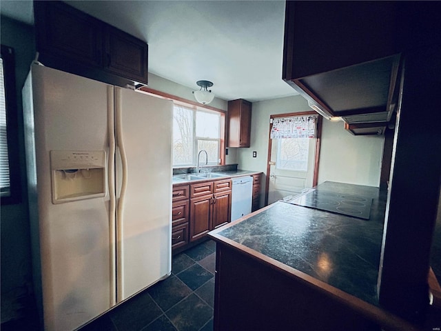 kitchen featuring white appliances, extractor fan, and sink