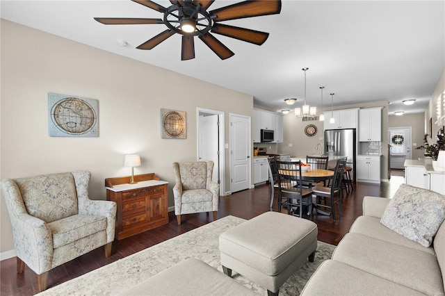 living room with dark hardwood / wood-style floors and ceiling fan