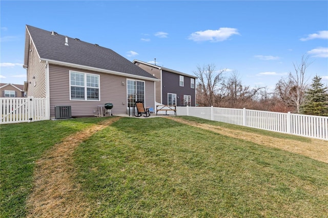 rear view of house featuring central AC, a patio, and a lawn