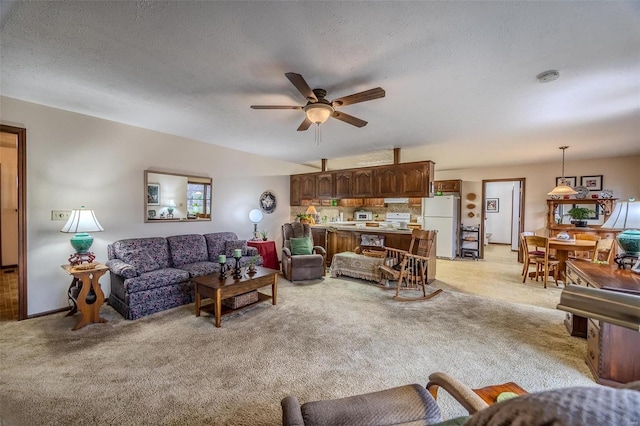 carpeted living room featuring a textured ceiling and ceiling fan