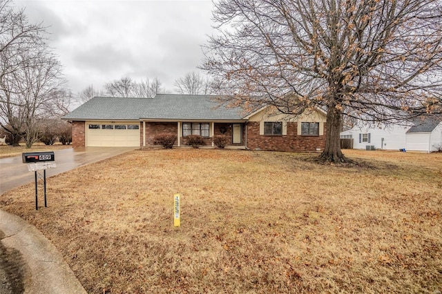 single story home featuring a garage and a front yard